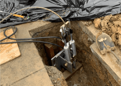 a construction site with a large hole in the ground, possibly a trench or a pit