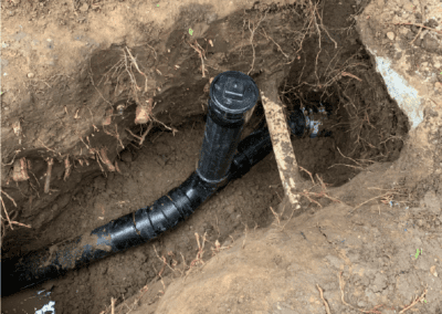 The pipe appears to be a water pipe, and it is surrounded by dirt and mud